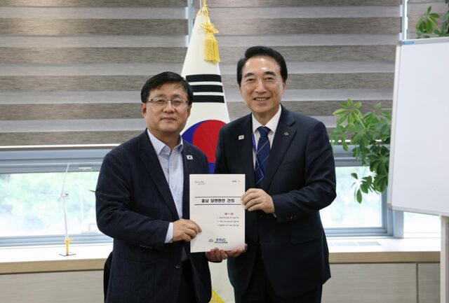 박수현 충남지사가 28일 김성환 기후에너지환경부 장관에게 발전공기업 통합본사 충남 유치 건의서를 전달하고 있다.